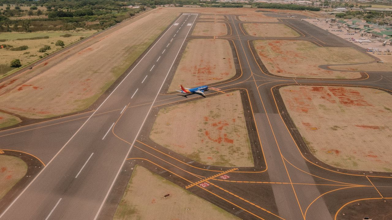 Elevated view across an airfield with runways and taxiways laid out below